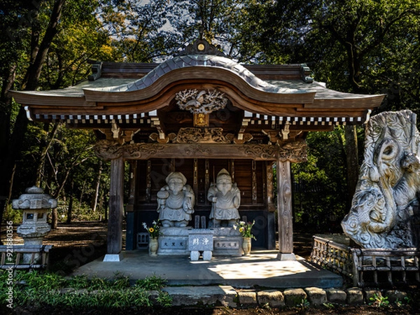 Fototapeta 残暑の陽射しの下の深大寺の大黒天と恵比寿尊の石像