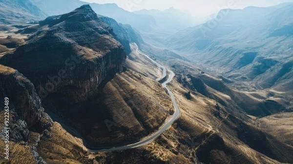 Fototapeta Overhead shot of a mountain pass with winding roads, clear sky for adding text