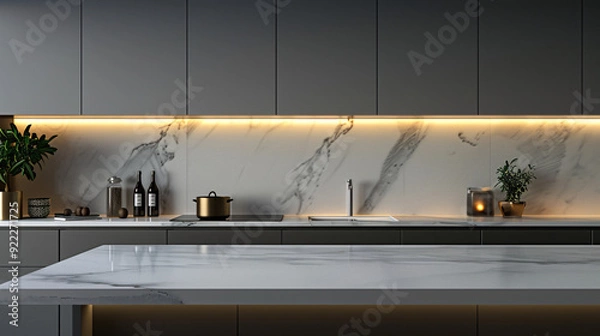 Fototapeta Modern kitchen with sleek gray cabinets and a white marble countertop. The warm light from the under-cabinet lighting creates a inviting atmosphere.