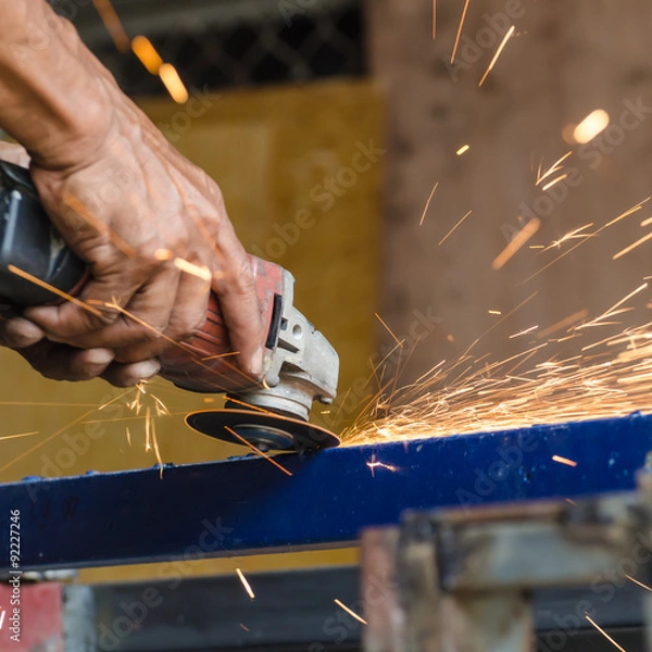 Obraz Electric wheel grinding on steel structure in factory