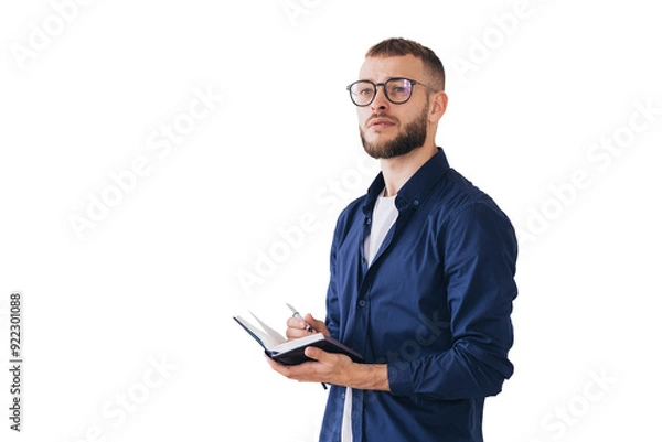 Fototapeta Thoughtful man with glasses writing in a notebook, deep in concentration. Wearing casual attire, he stands isolated on a transparent background