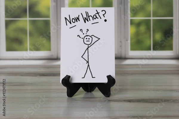 Obraz Sign with stick figure scratching head with question marks, Now What? Hand written.