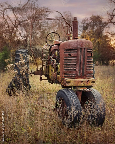 Obraz old rusty farm tractor in field