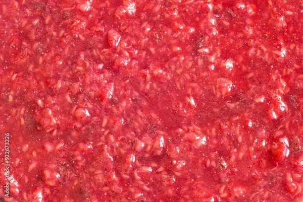 Fototapeta This vibrant close-up image showcases the rich texture of crushed natural raspberries. The mix of red and pink hues highlights the freshness of the fruit, with visible seeds adding to the organic feel