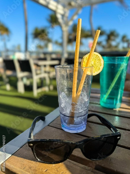 Fototapeta Empty drink glasses sit on patio table at Florida restaurant