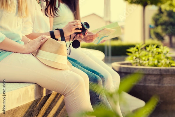 Fototapeta Three attractive tourist girlfriends