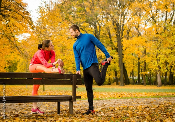 Fototapeta Couple stretching before jogging