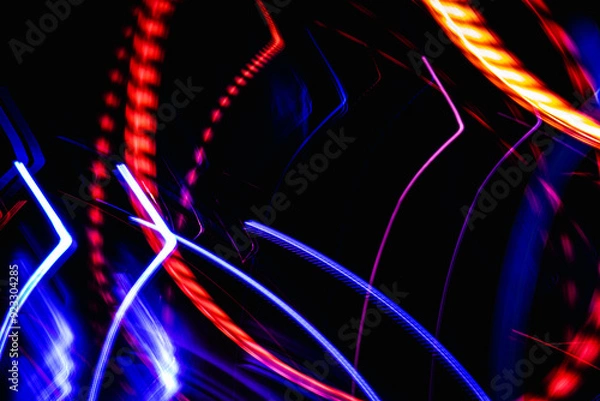 Obraz A colorful, abstract image with red, blue, and yellow lines. The image has a dynamic, energetic feel to it, with the colors and shapes creating a sense of movement and excitement
