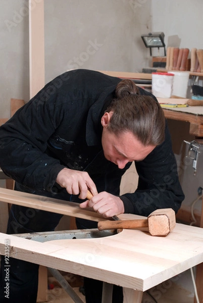 Obraz Young carpenter working in his workshop with hand tools