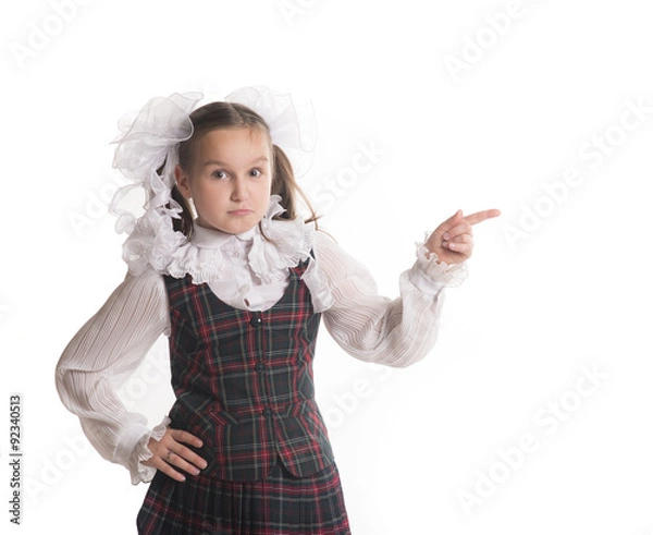 Obraz Школьница с белыми бантиками указывает на белый фон 