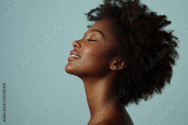Fototapeta A close up of a black woman's face with her eyes closed