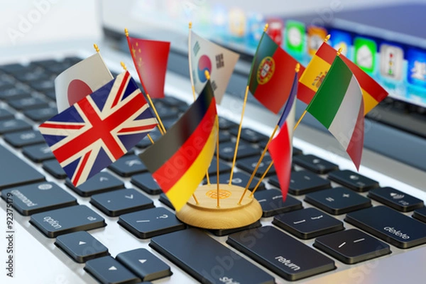 Obraz Global communication and business concept, translate and e-learning, national flags of the world countries on computer laptop keyboard