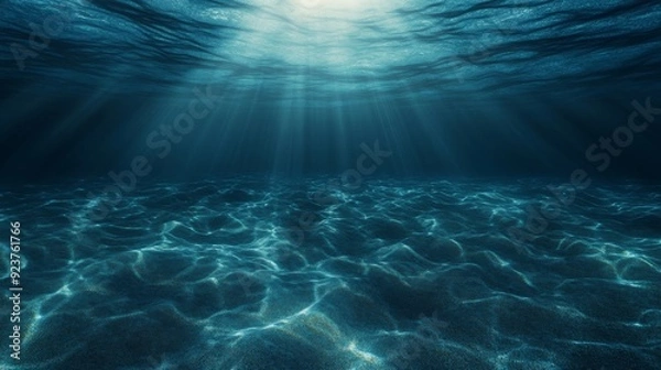 Obraz Sunlight pierces through the water, softly illuminating the ocean floor in this underwater perspective