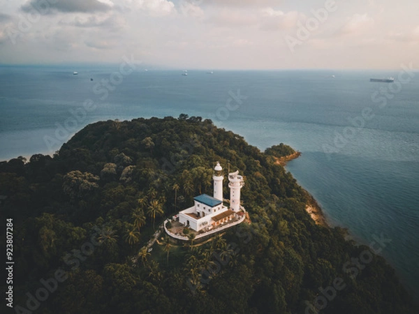 Fototapeta Cape Rachado Lighthouse, Malaysia's oldest, sits atop a wooded hill in Port Dickson. The 16th century, it offers scenic sea views, birdwatching, and trails through the lush Tanjung Tuan Reserve.