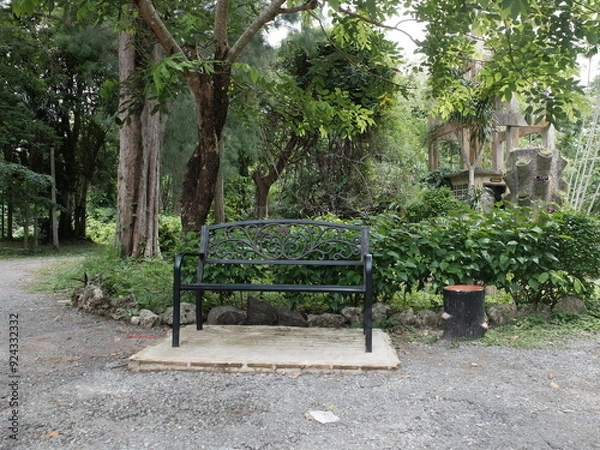 Fototapeta Front view of metal old bench in the park.