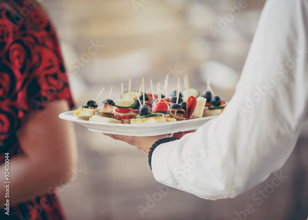 Obraz waiter serving appetizers during a catered event
