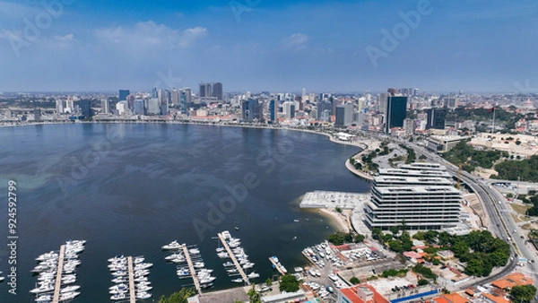 Fototapeta Aerial view of Luanda's coastline and urban skyline during a clear day