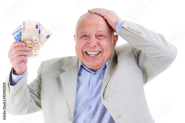 Fototapeta Portrait of Happy and smile old mature businessman in suit, hold euro money in hand and put second hand over head isolated on white background. Positive human emotion, facial expression