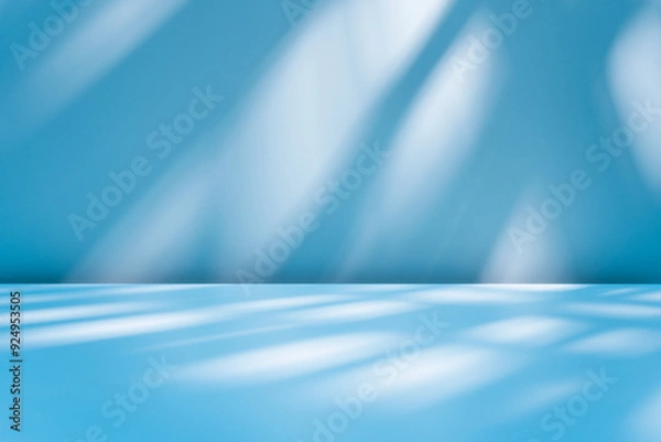 Obraz Abstract blue background for product presentation with sunlight and blurred shadows wall. Winter background.
