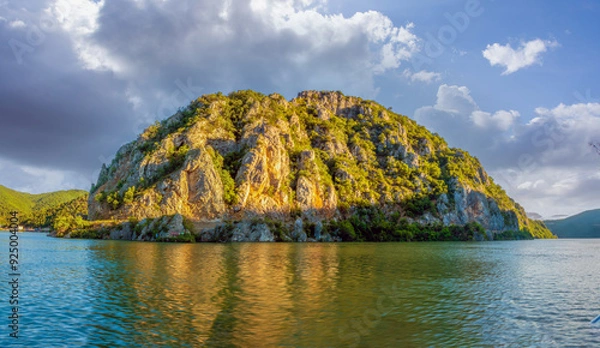 Fototapeta Dramatic rocky mountain forcing a bend of the Danube river along the Iron Gates gorge, between Serbia and Romania