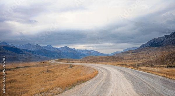 Fototapeta A road winds its way through a wilderness landscape setting. With copy space.