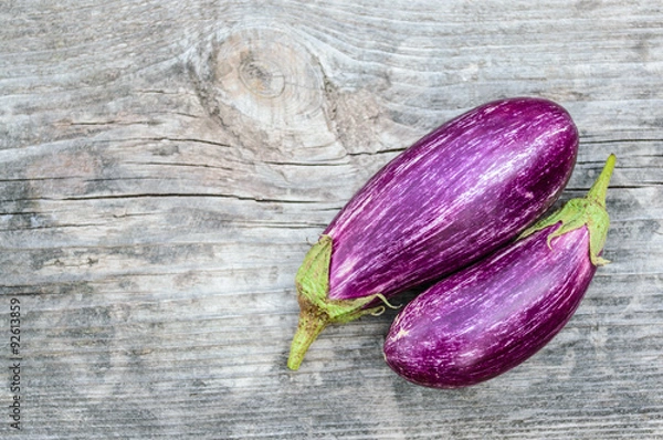 Obraz Two purple eggplants on the wooden board