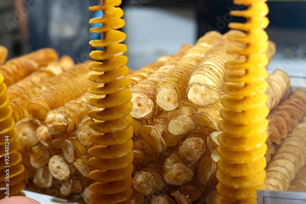 Obraz Tornado potato also called twist potato or potato twister on a stick at a street food stall