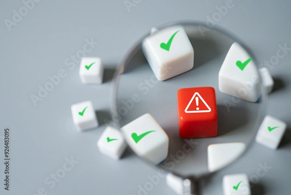 Fototapeta Magnifier zoom in to close up to identify red danger risk cube among other normal incident. Risk management concept for business and personal planning for risk mitigation.