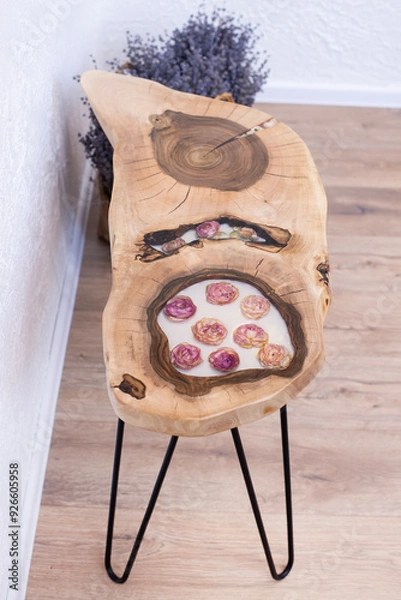 Fototapeta Table in loft style. Wooden table with epoxy resin and dry flowers. In the interior
