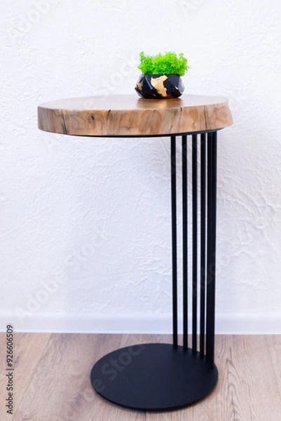 Fototapeta A coffee table made of a wooden slab. Table made of epoxy resin. Loft style. Wooden vision with annual rings. The end of the table