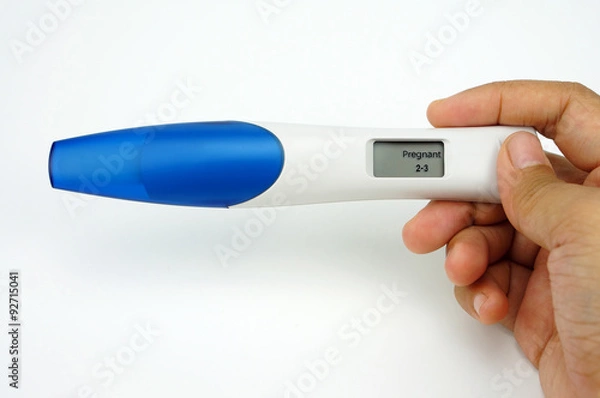 Obraz Holding digital pregnancy test isolated on white background. The