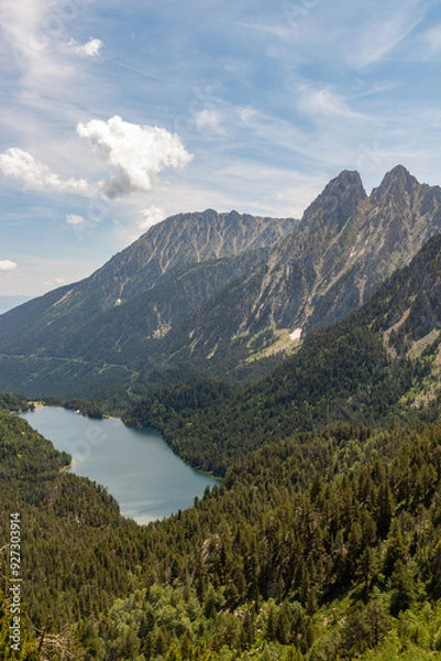Fototapeta Mountain panorama on two peaks with forest and lake in the valley