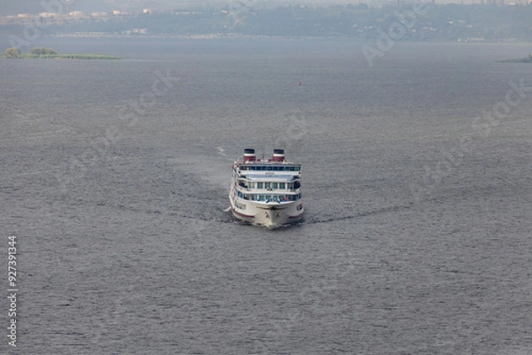 Fototapeta A four-deck twin-tube cruise ship on a river, sea or lake.