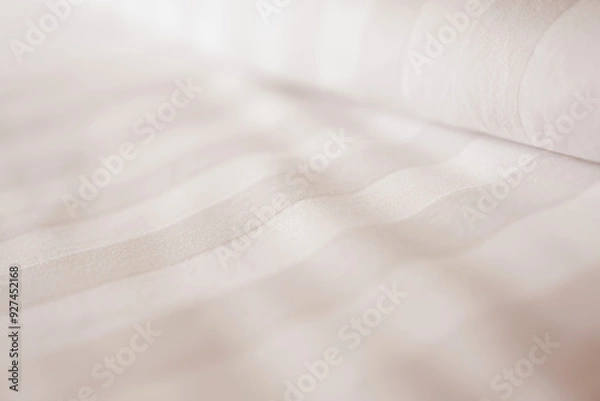 Fototapeta Pillow and bedsheet on empty bed, close up and blur background. Soft and calm atmosphere of cozy bed room. 