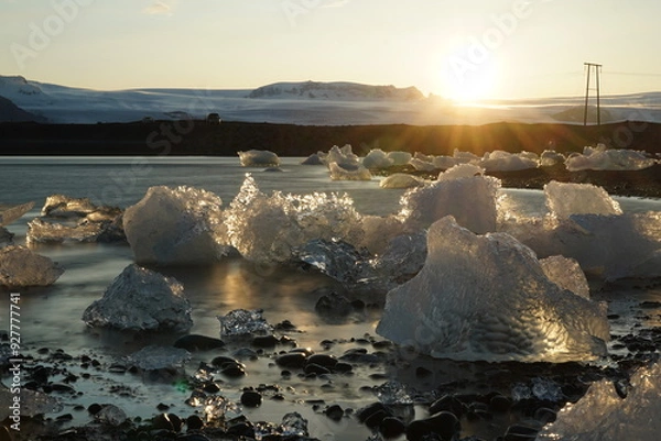 Fototapeta Ice chunk in the incredible Jokulsarlon glacial lagoon in Iceland at sunset in spring. horizontal image