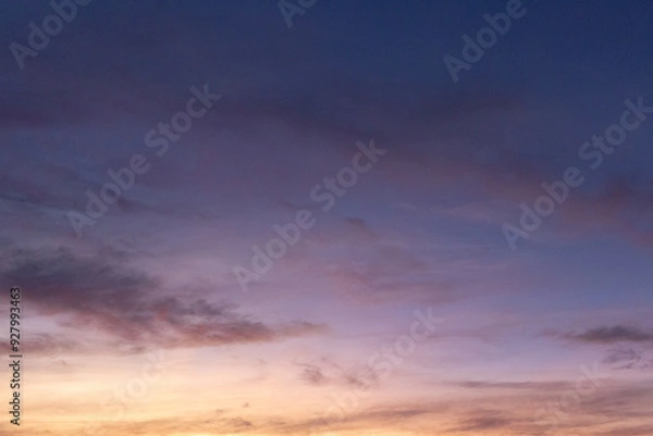 Fototapeta A serene evening sky with soft hues of purple, pink, and orange, fading into twilight