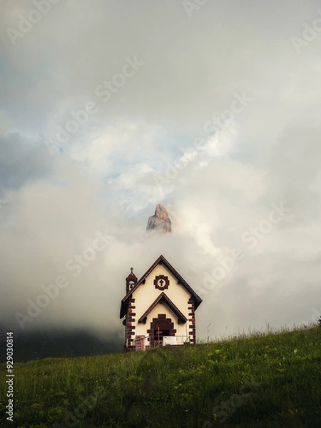 Fototapeta Vertical photo of a little alpine church in the dolomites region 