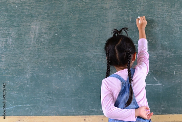 Fototapeta Kid write on chalkboard