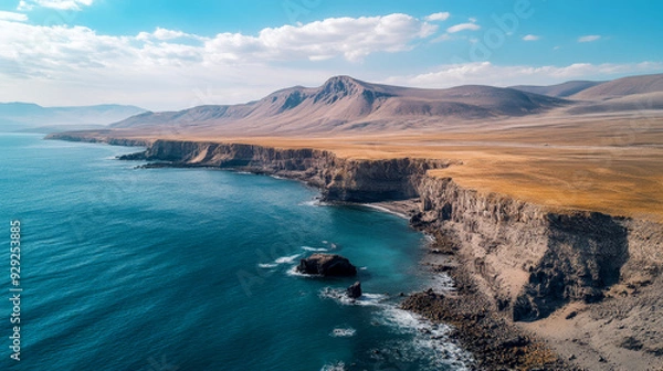 Fototapeta Aerial view of a serene beach with crystal-clear turquoise waters and lush green forest. Perfect for nature, travel, and tropical getaway concepts.