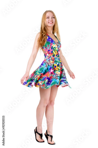 Fototapeta Full length of young cute smile girl stands on tiptoe in summer dress posing isolated on white background, positive human emotion, facial expression