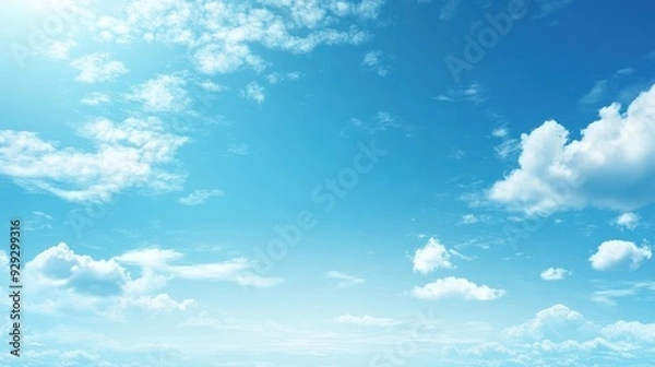 Fototapeta A serene blue sky with scattered clouds, evoking a sense of calm and tranquility.
