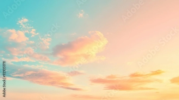 Fototapeta A serene sky at sunset with soft clouds and a gradient of warm colors.