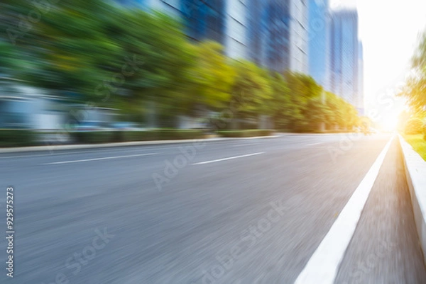 Fototapeta blurred empty urban road and modern buildings at a sunny day, shanghai, china