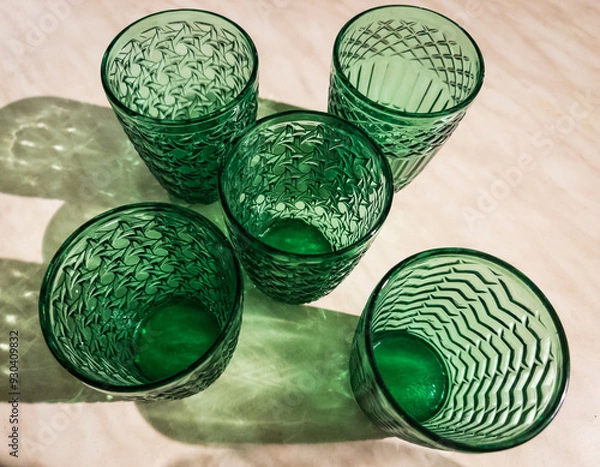 Obraz Five Green patterened Glasses and  reflections on white background , empty