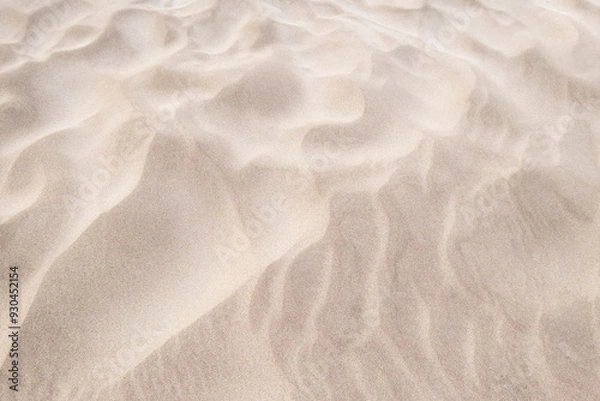 Fototapeta wind patterns on the sand of the beach, texture of a dune with waves made by the action of the wind, background