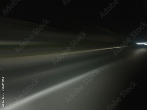 Fototapeta Gray light road trails, long time exposure motion blur effect. Night. Acceleration speed motion. Modern abstract high-speed light effect. 