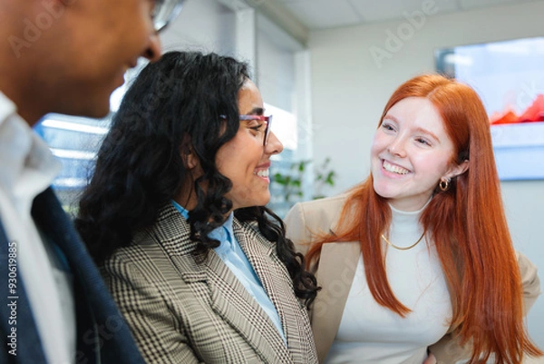 Fototapeta Close up of young smiling latin businesspeople team collaborating and doing business working in a meeting room office 