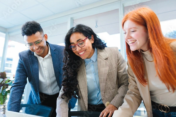 Fototapeta Close up of young smiling latin businesspeople team collaborating and doing business working in a meeting room office 