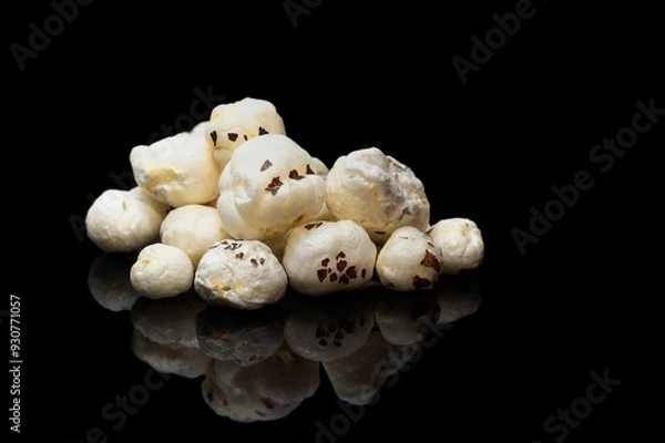 Obraz Fox Nut or Makhana Isolated on Black Background with Reflection and Copy Space, Also Known as Lotus Seed Pop, Euryale Ferox or Gorgon Nut