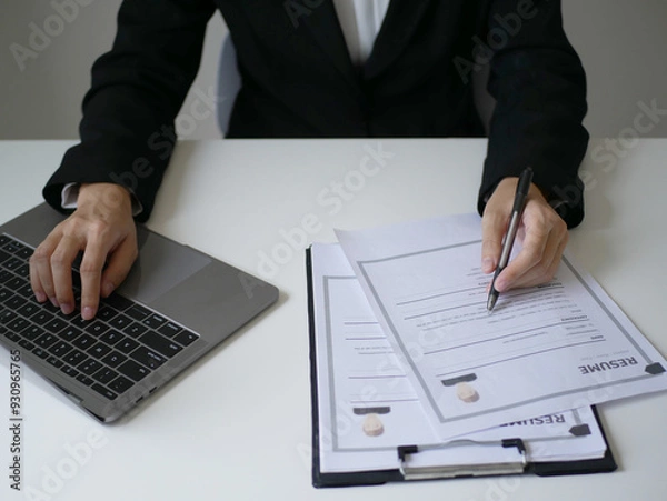 Fototapeta Business woman employer holds resume and talks with job applicant for job interview about her career and personal history in company, recruitment concept